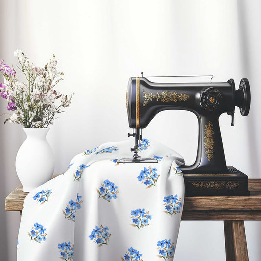 Printed Fabric with Handpainted Blue Watercolor Floral Pattern, FACS-1405, on an antique sewing machine sitting on a desk with vase of beautiful flowers.
