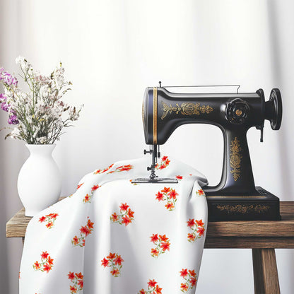 Printed Fabric with Handpainted Red Watercolor Floral Pattern, FACS-1415, on an antique sewing machine sitting on a desk with vase of beautiful flowers.