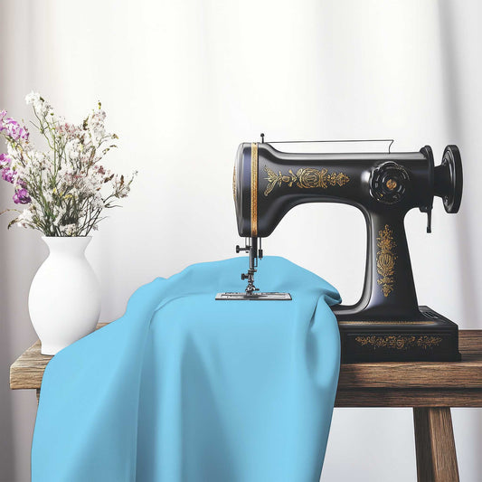 Blue Cotton Sateen Handpainted Purple Watercolor Print, FACS-1430-999, on an antique sewing machine sitting on a desk with vase of beautiful flowers.