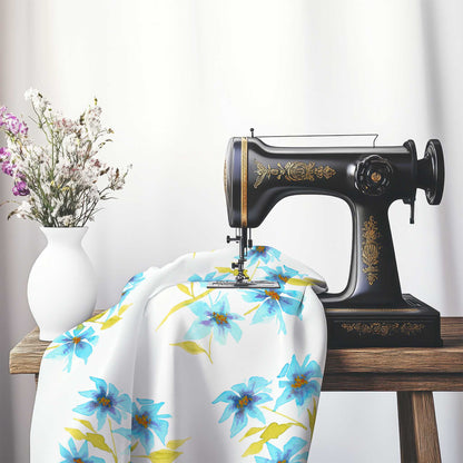 Printed Fabric with Handpainted Blue Watercolor Floral, FACS-1434, on an antique sewing machine sitting on a desk with vase of beautiful flowers.