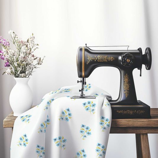 Printed Fabric with Handpainted Blue Watercolor Floral Pattern, FACS-1435, on an antique sewing machine sitting on a desk with vase of beautiful flowers.