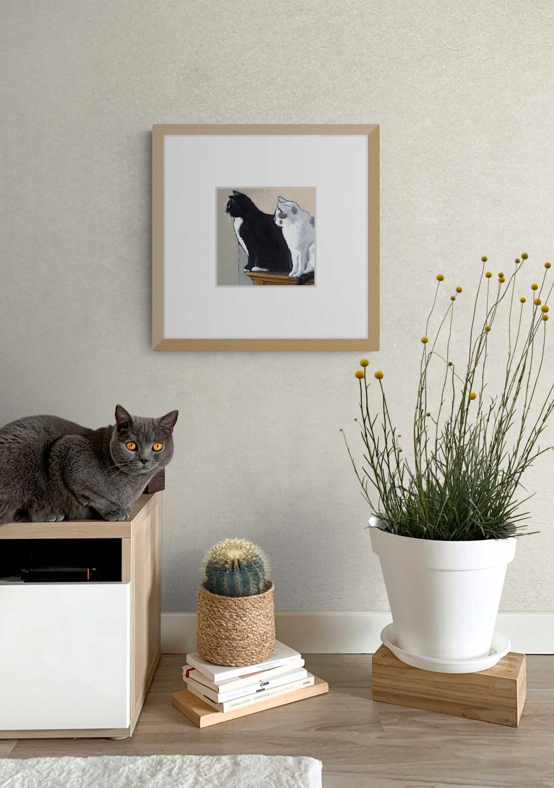 Black Cat White Cat Fine Art Print with Faux Mat Board | Styled in Calm Japandi Entryway with Oak Media Unit, Grey Cat, Wicker Cactus Planter and Billy Button Stems