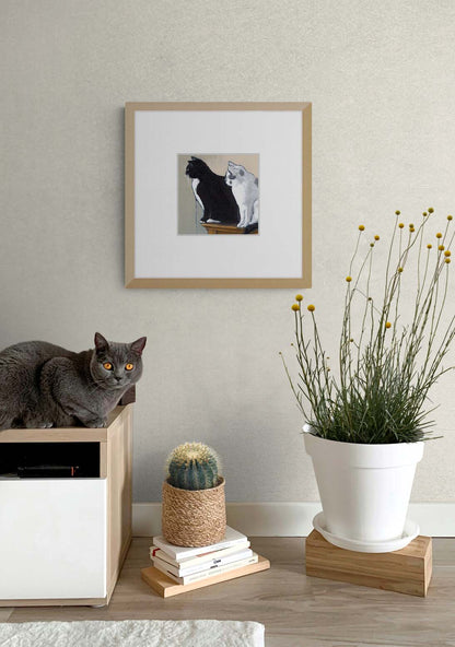 Black Cat White Cat Fine Art Print with Faux Mat Board | Styled in Calm Japandi Entryway with Oak Media Unit, Grey Cat, Wicker Cactus Planter and Billy Button Stems